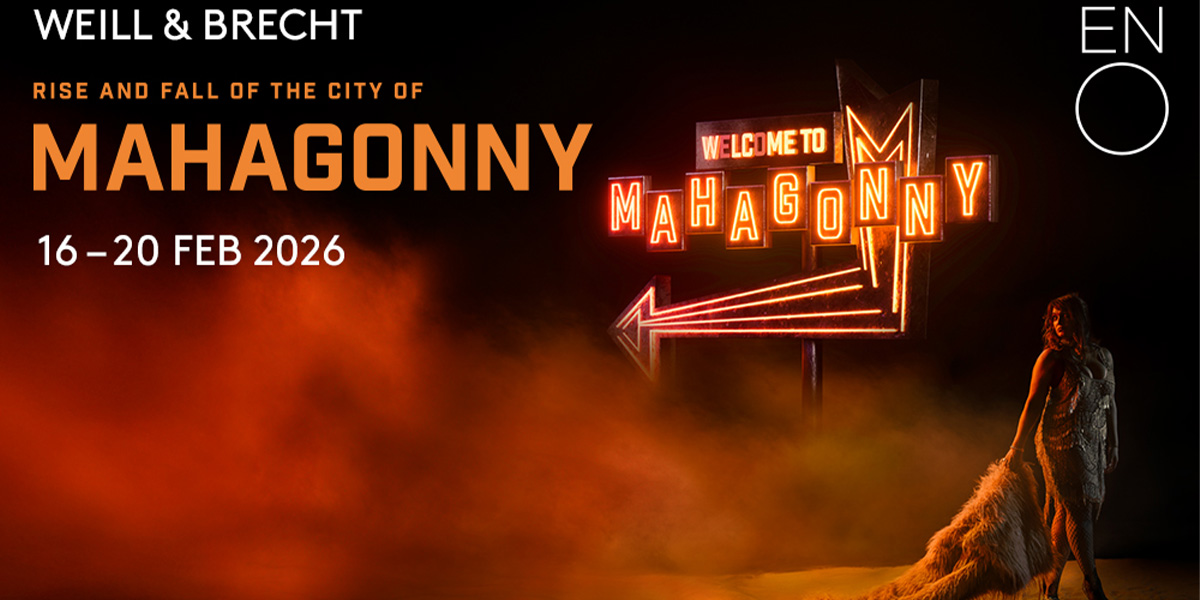 The background shows a stage full of haze and orange lighting. On the left it reads 'Rise And Fall Of The City Of Mahagonny' on the right is an image of a person carrying a fur coat. Above the person is a sign which says 'Welcome To Mahagonny'