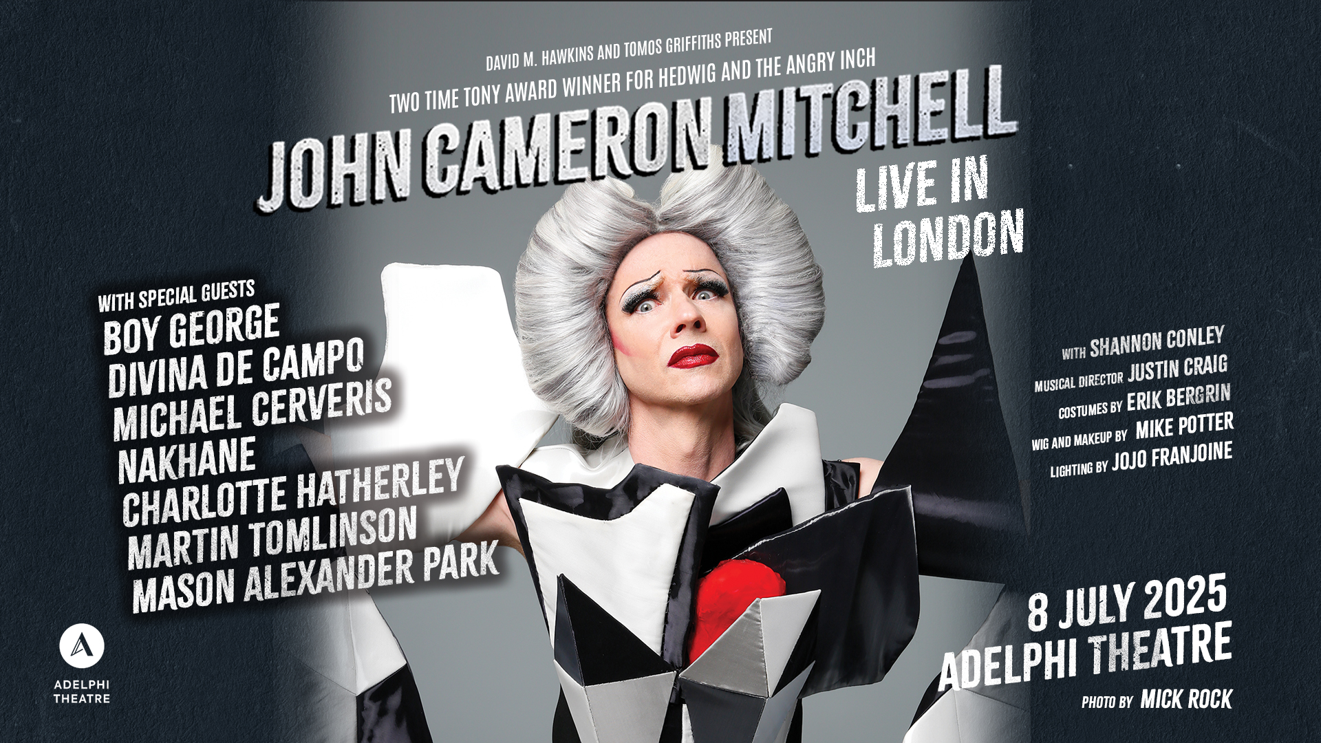 Promotional image for John Cameron Mitchells show. They are wearing a grey wig and a black and white checked dress. 