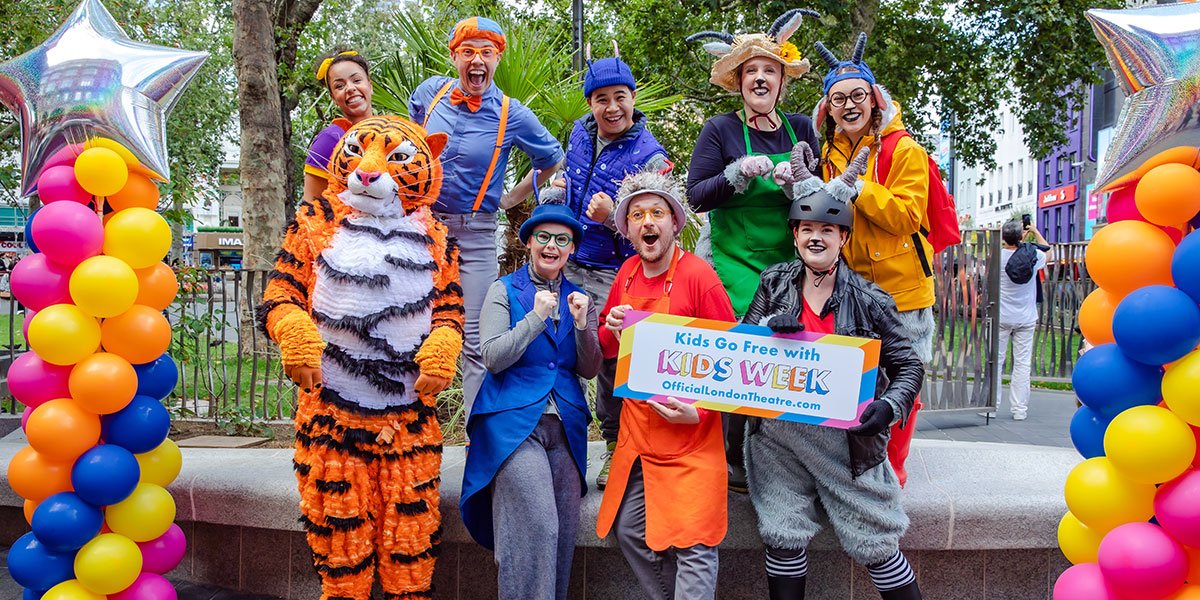Casts from children's shows dressed in colourful costumes (including a Tiger) stand outside the TKTS booth
