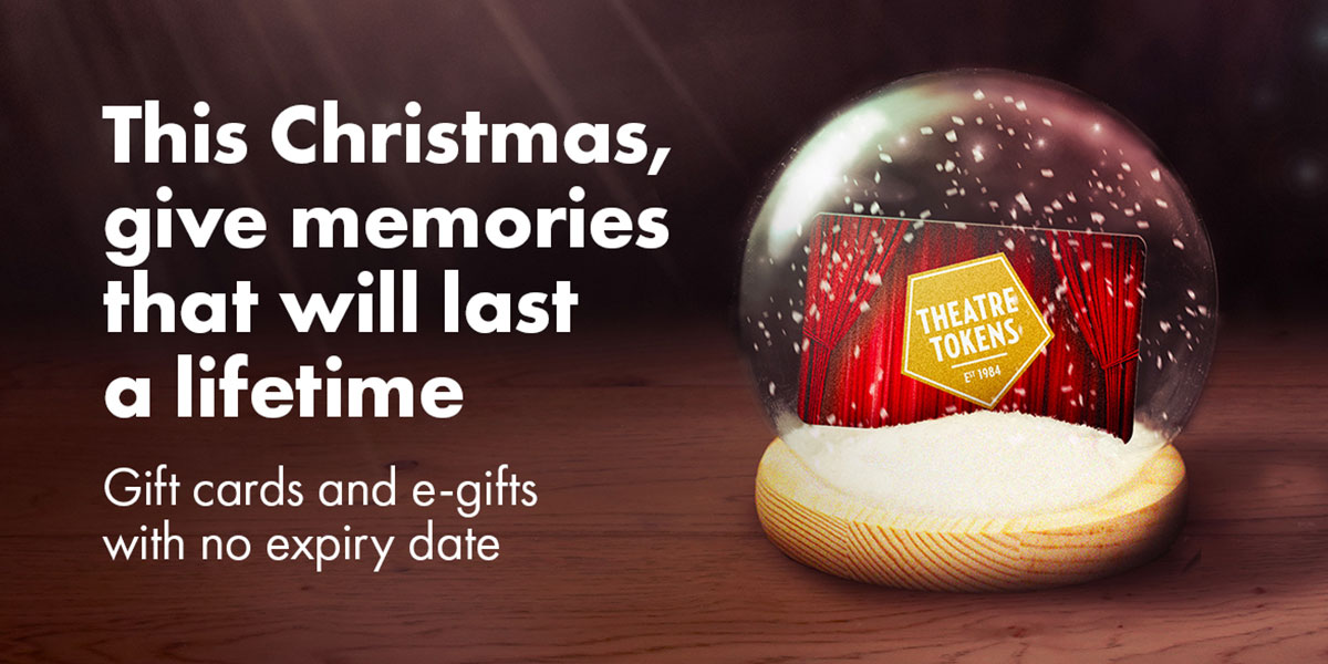 Colourful Christmas tokens featuring festive designs, displayed on a wooden surface with soft lighting.