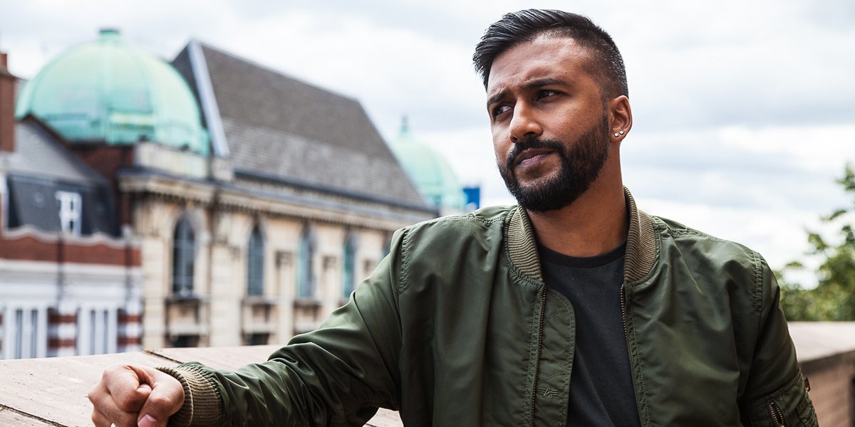 Yamin Choudry and Katherine Leesdale pose together, smiling, against a neutral background.