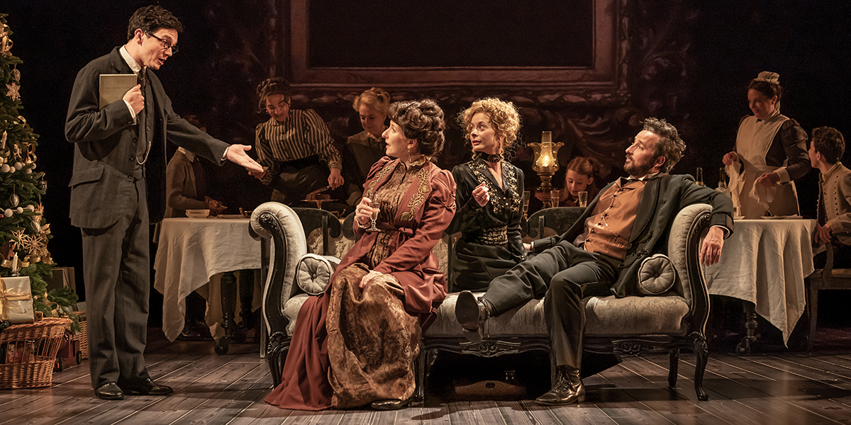 A group of actors from the Leopoldstadt Company poses together, wearing diverse costumes against a neutral background.